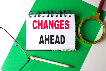 CHANGES AHEAD text on notebook on green paper