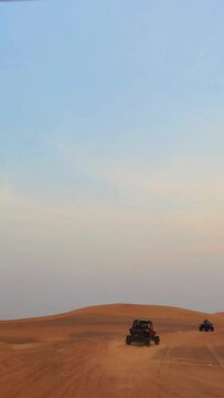 person riding a bike,  Offroad safari in sand desert, Empty Quarter Desert in United Arab Emirates. Quad bike on sand dune in Rub’