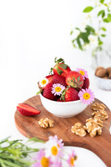 Obraz na płótnie Canvas Healthy Snack with Organic Strawberries and Walnuts. Wholesome Vegetarian and Vegan Alternatives.