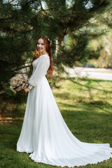 red-haired girl bride with a wedding bouquet