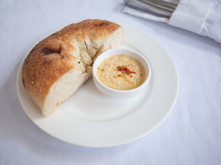 hummus and bread as appetizer on the white plate in tatar restaurant in capital kyiv