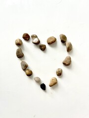 A heart made of stones on a white background