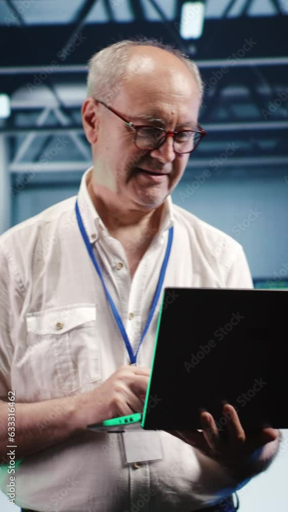 Poster vertical video overseeing supervisor expertly managing data while navigating in industrial server ro