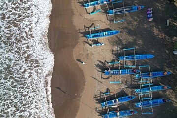 fishing boats anchored on the shore. Indonesia is the largest maritime country in the world that...