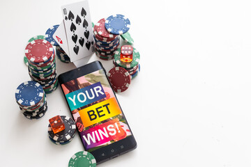 Smartphone screen with mobile app for betting and score. Device with match results on screen, sportsman on background during match. Gambling, betting, sport, finance, modern technologies concept.