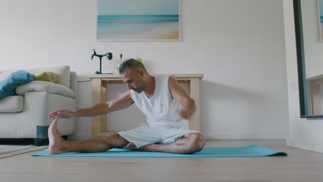 40 year old man does morning yoga to relieve back pain and stress