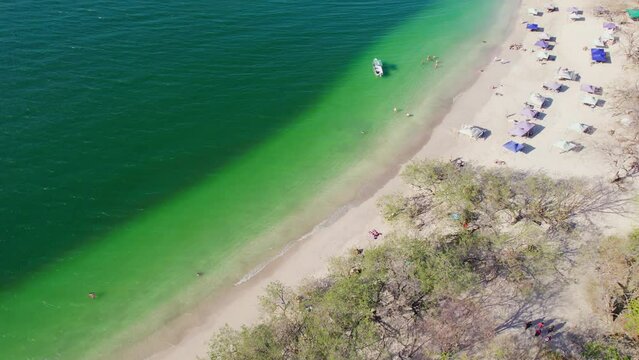 Conchal Beach Shore Costa Rica With Blue Ocean And Tourists On Sandy Shore, 4K Aerial Drone