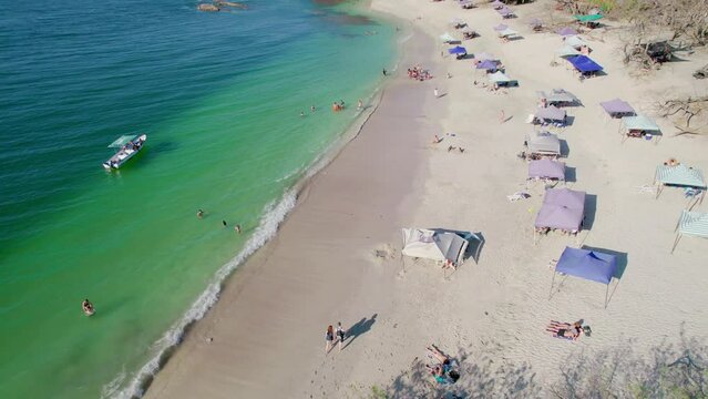 Popular Tourist Destination Beach Playa Conchal Beach Costa Rica With Beach Tents On Summer Day, 4K Aerial Drone