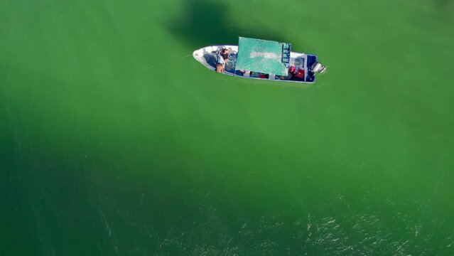 Top Down Birdseye Drone View Of Fishing Boat In Green Ocean Water Off Costa Rica, 4K Aerial