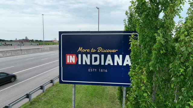 More to Discover in Indiana state border road sign. Aerial establishing shot of Welcome to Indiana landmark.