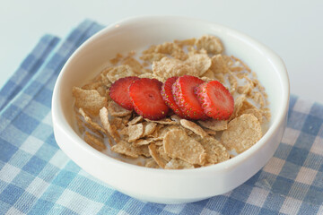A bowl of toasted wheat cereal with freeze dried strawberries