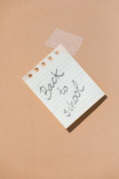 Note with message back to school pasted on wall