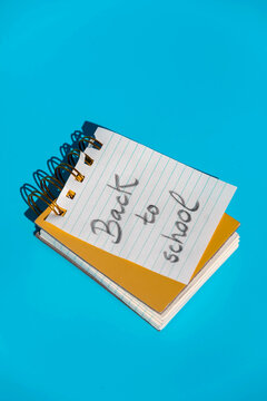 Opened spiral notebook with hardcovers with message back to school