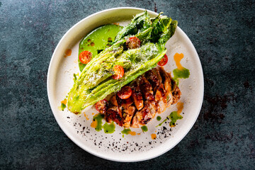 chicken grill meat served with pak choi vegetables on plate