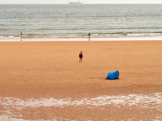 Beach at low tide in a city. Gijon. Asturias. Spain