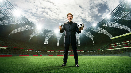 Man in suit celebrating successful betting activity, standing with football ball and money on 3d...