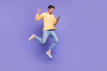 Full body length cadre of funky jump student guy blogger fist up his love girlfriend answer question isolated on purple color background