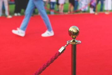 Red carpet with ropes and golden barriers on a luxury party entrance, cinema premiere film festival...