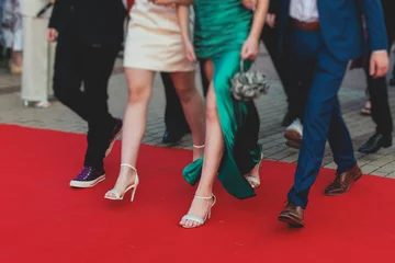 Fotobehang Red carpet with ropes and golden barriers on a luxury party entrance, cinema premiere film festival event award gala ceremony, wealthy rich guests arriving, outdoor decoration elements, summer day © tsuguliev