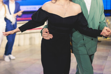 High school graduates dancing waltz and classical ball dance in dresses and suits on school prom...