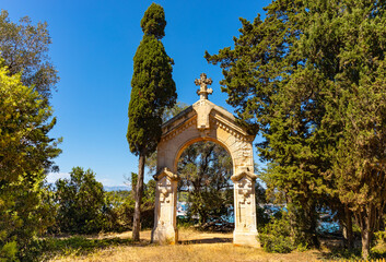 Ile Saint Honorat island with seafront arch shrine of Abbaye de Lerins monastery at Mediterranean Sea offshore Cannes at French Riviera in France - 633341030