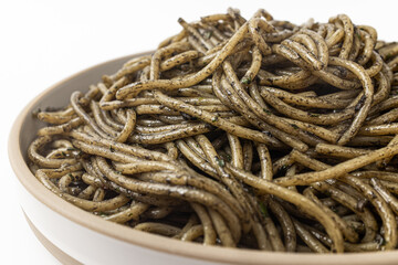 Pasta with squid ink sauce on a white background