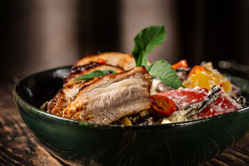 Baked pork ribs with baked vegetables: pepper, onion, tomato, eggplant, zucchini and basil, Restaurant dishes for home cooking.