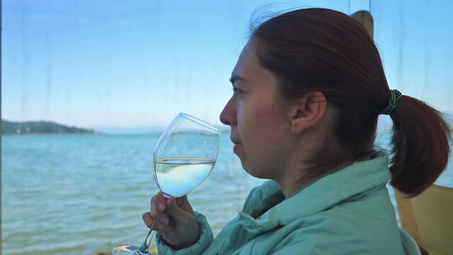 Woman tasting white wine, Waving wine in the wineglass. 4k footage UHD 3840x2160 