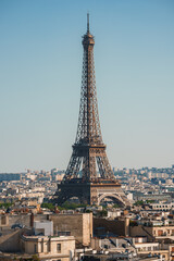 Daytime shot of the Eiffel Tower under a clear blue sky in Paris, France.