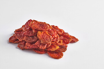 Delicious dry tomato and dry fruits on the background, close up style, in the plate still life.