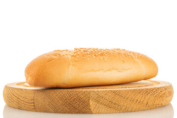 One delicious fragrant bagel on a round wooden tray, close-up, isolated on white.