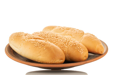 Three fragrant rolls on a clay plate, close-up, isolated on white.