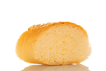 One slice of fragrant bun sprinkled with sesame seeds, close-up, isolated on white.