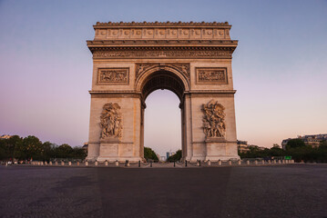 Fototapeta na wymiar Arc de Triomphe in Paris, France under a purple sky with a cloudy weather and city landscape.