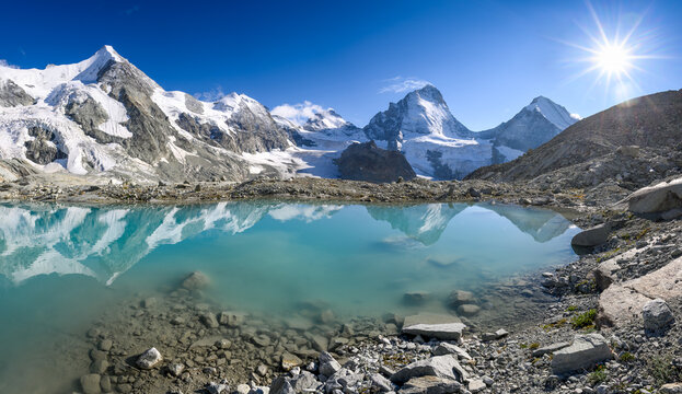 alpine panorama from Cabane du Mountet with Wellenkuppe, Obergabelhorn, Arbenhorn, Pointe du Zinal, Dent Blanche at a glacier lake, Valais