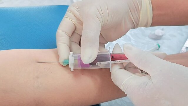 Close up hand of nurse, taking blood sample from a patient in the hospital