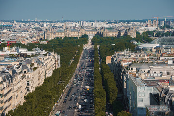 Aerial drone shot of the Eiffel Tower and Paris cityscape on a sunny summer day.