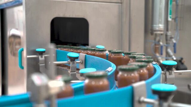 Canned food on the production line in the food factory 4K