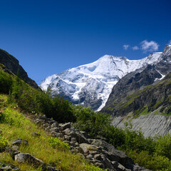 Fototapeta na wymiar wild river bed of Navisence in Val d'Annivers with peak of Grand Cornier, Valais