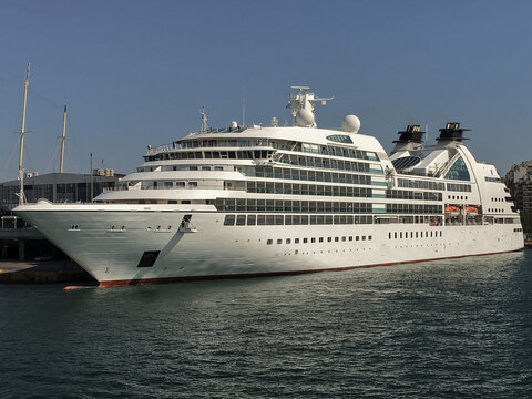 Luxury Seabourn yacht cruiseship cruise ship liner Quest in Ketchikan, Alaska with pier, port infrastructure and mountain scenery coast line nature landscape