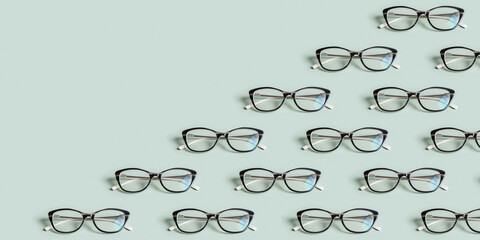 Glasses for vision on a green background with copy space. Optical store, vision test, stylish...