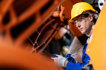 A team of engineers meeting to inspect computer-controlled steel welding robots. Plan for rehearsals and installation for use.