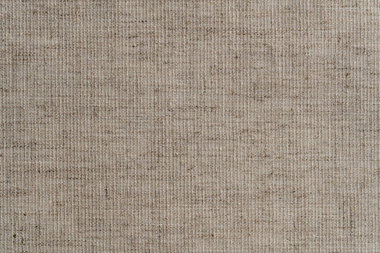 Natural vintage linen texture as background, macro. Light cream linen fabric texture, old rustic canvas. Top view, closeup
