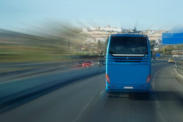 Tourist bus on a highway, motion blur effect - back view