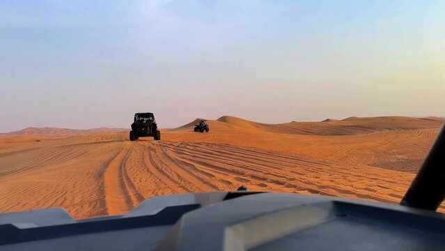 Riding buggies in the desert during sunset