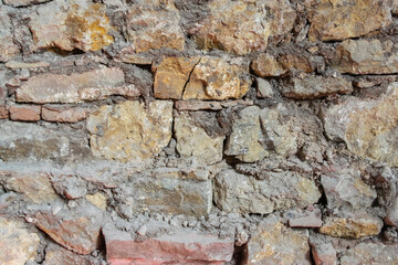 Stone wall with old bricks of the acient castle.