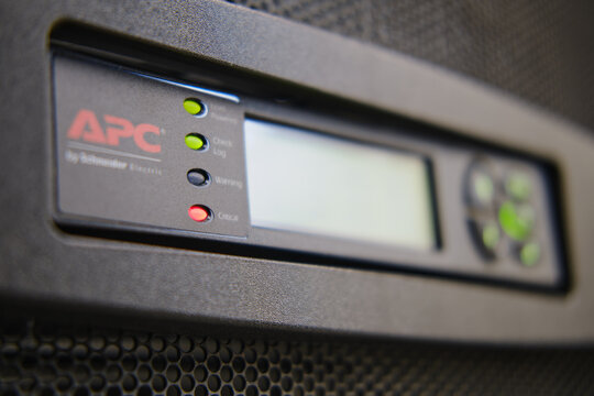 Control panel APC with alarm module of uninterruptible power supply system ups in server room, red light warning error - Moscow, Russia, 06, 02, 2022