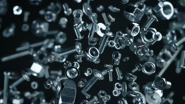 Super Slow Motion Shot of Fasteners Explosion Towards Camera Isolated on Black at 1000fps.