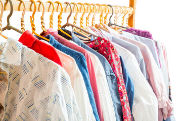 Clothes are hanging on hangers. Lots of clothes for sorting things in the wardrobe. - 633381494