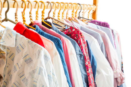 Clothes are hanging on hangers. Lots of clothes for sorting things in the wardrobe.